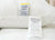 Close-up of two white tags on a Sysco Guest Supply Dream Escape Down Alternative Pillow (formerly Dream Essence). One tag notes antimicrobial features; the other lists care and materials for this hypoallergenic polyester pillow made in Pakistan.