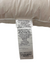 A close-up of the Pillow Factory Downlite 75/25 Waterfowl Feather/White Down Pillow tag shows contents as 75% white waterfowl feather, 25% white down; assembled in the USA from materials made in China.